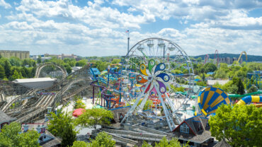 A wide view of Hersheypark showing the iconic ferris wheel and several roller coasters.