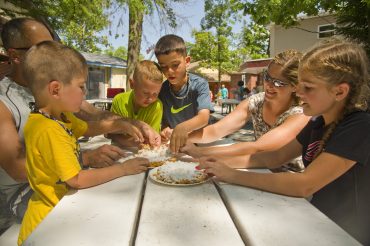 Knoebels Grove Amusement Park. Family sharing funnel cake.